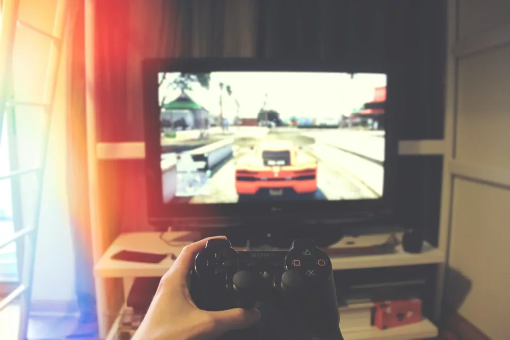 Playstation Controller In A Persons Hand, and GTA V GamePlay On TV Screen