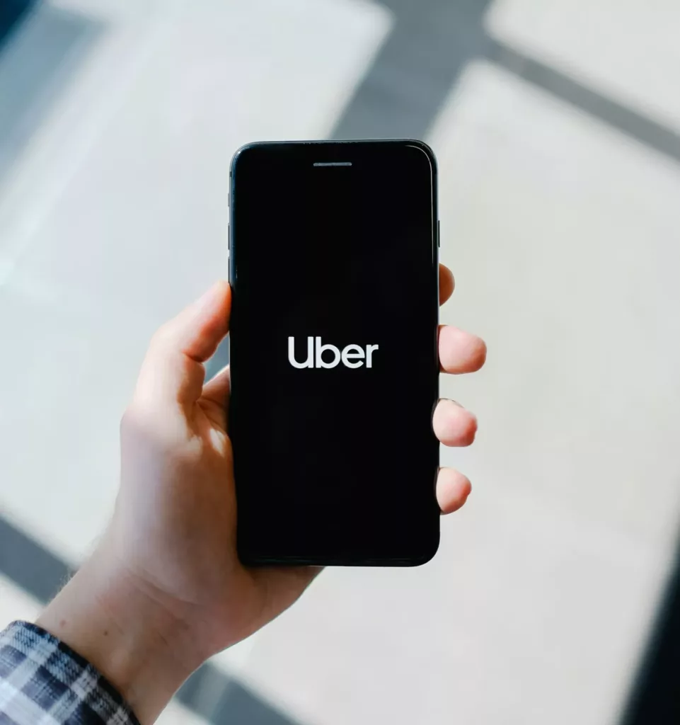 Uber On Phone Screen With Black Background.