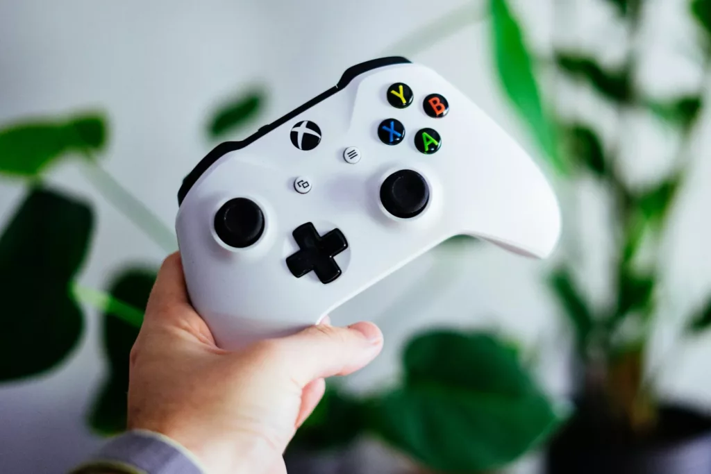Xbox's Controller In Persons Hand.