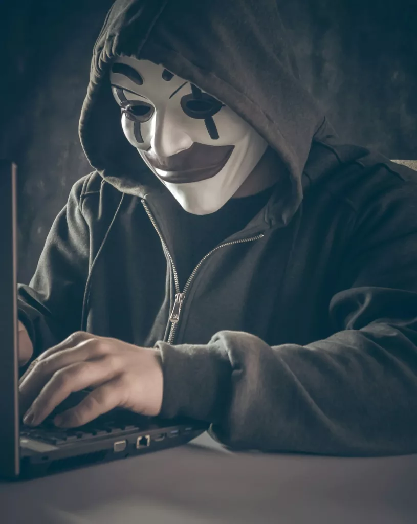 AN UNKNOWN PERSON USING LAPTOP & TYPING