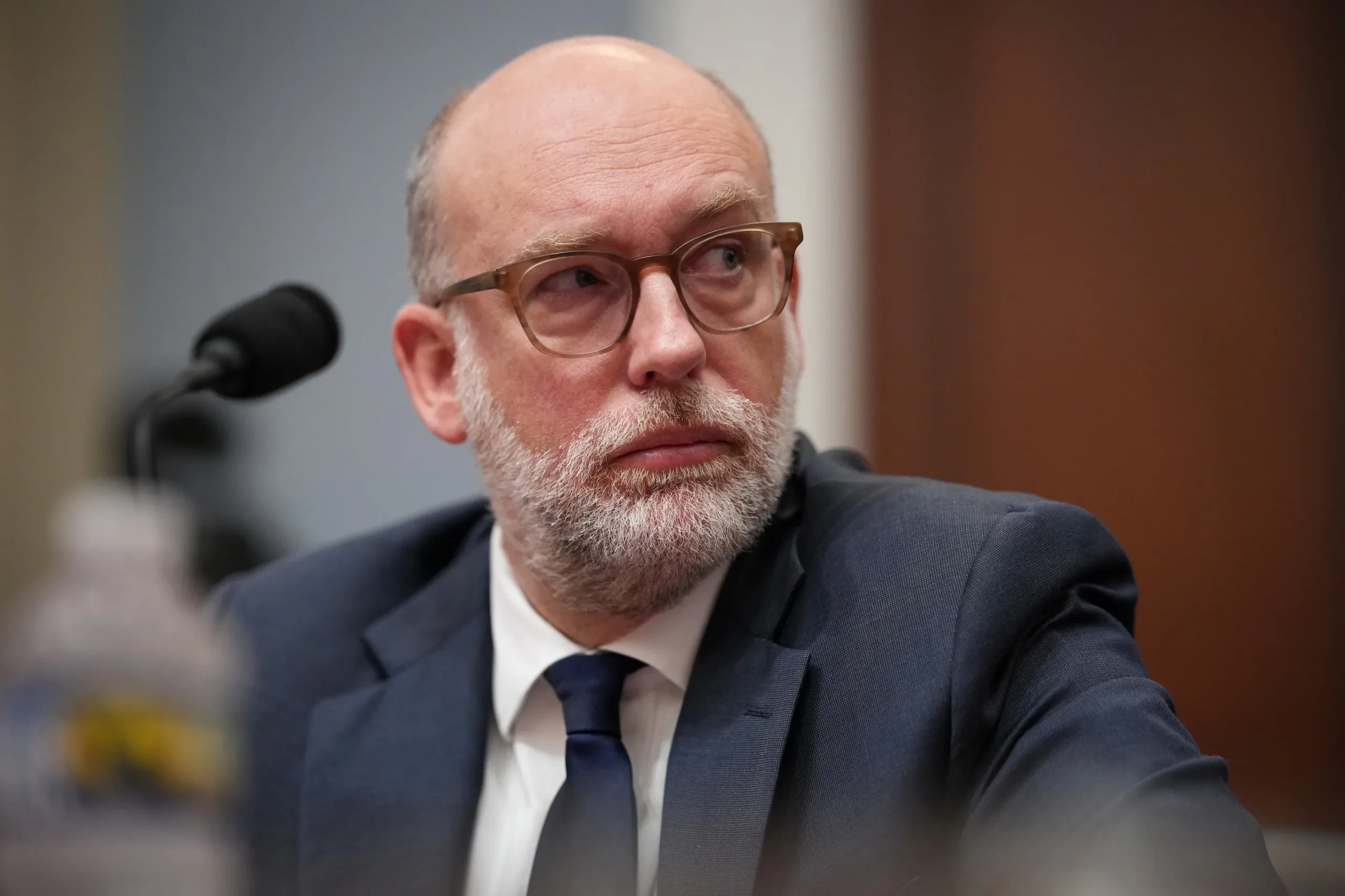 Shocking New Rules Would Give Political Appointees Final Say on Resear Close-up of Russell Vought testifying before the House Budget Committee on April 15, 2026.