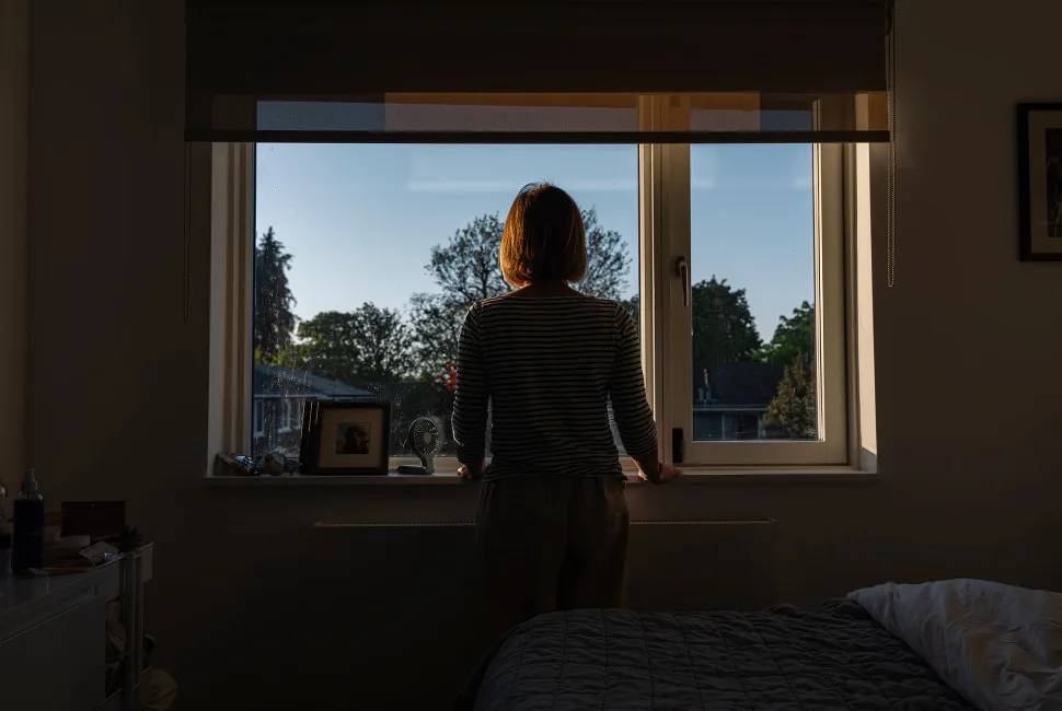 Surprising Link Between Estrogen Loss and Memory Decline Revealed A silhouetted woman looks out a window