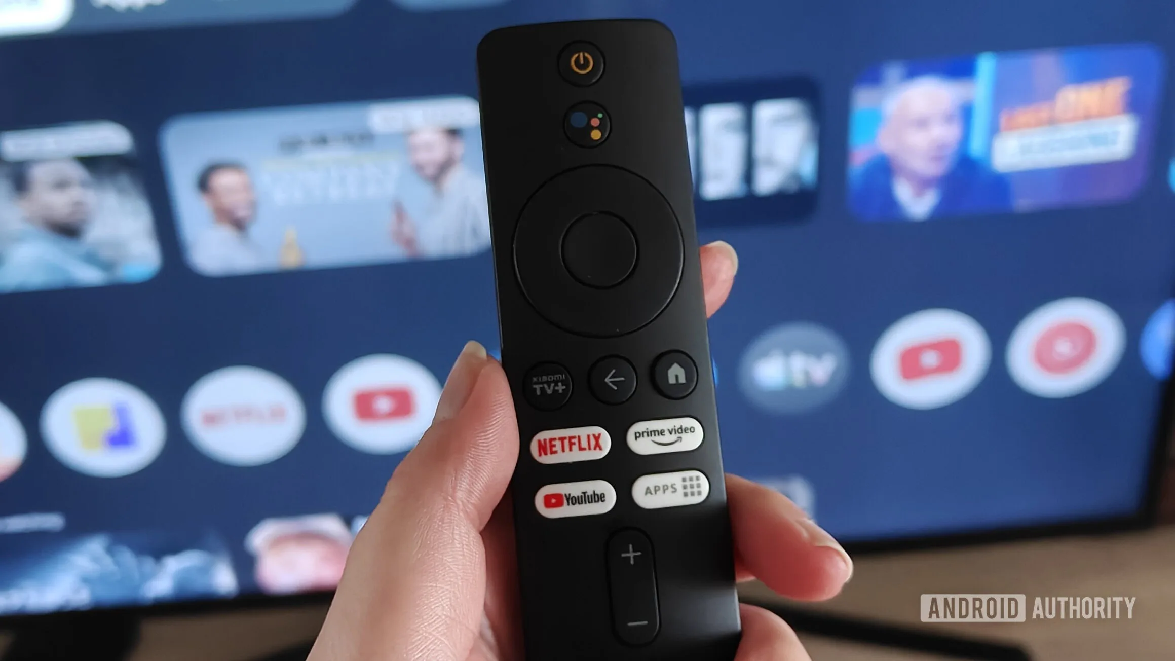 Google TV World Cup Hub: Live Matches, Highlights & Analysis Google TV World Cup 2026 — a remote held in a hand with the google tv interface on a screen in the background
