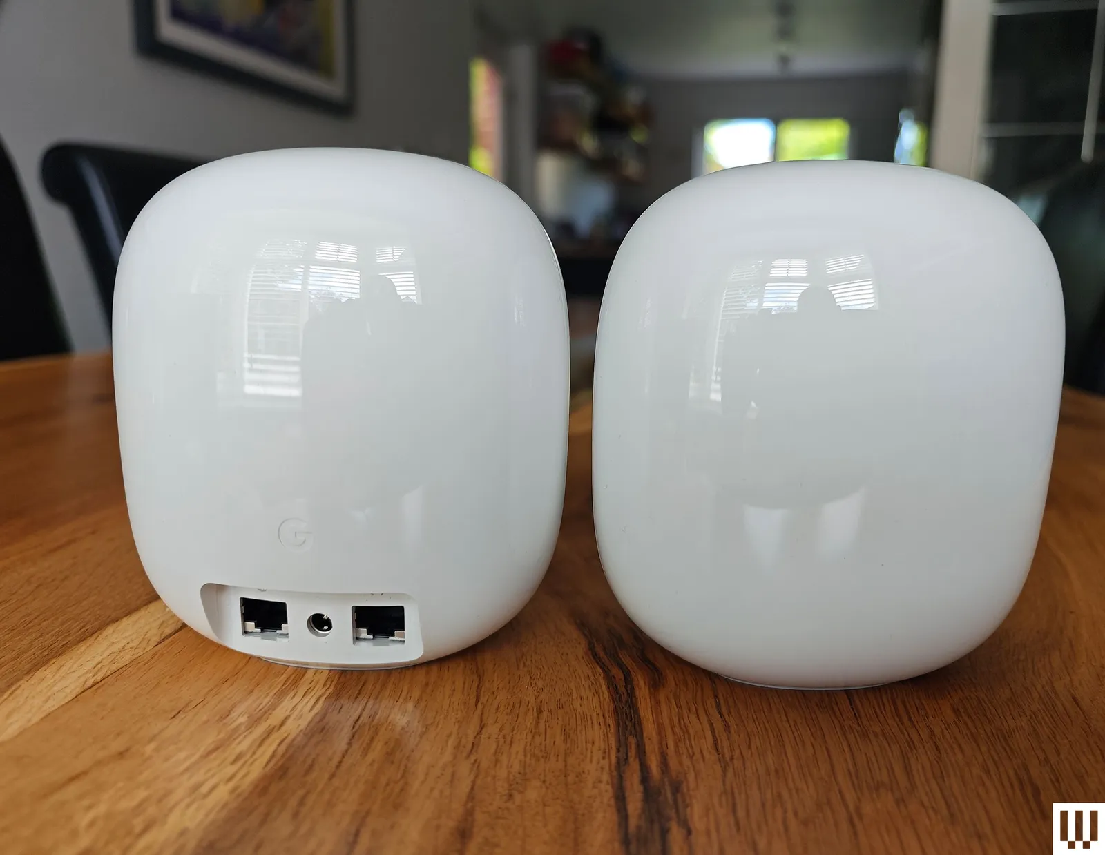 Best Mesh Wi-Fi Systems in 2026: Top 7 Picks Tested and Ranked Two white round Google Nest mesh wifi router devices one facing front and the other backwards showing the ports