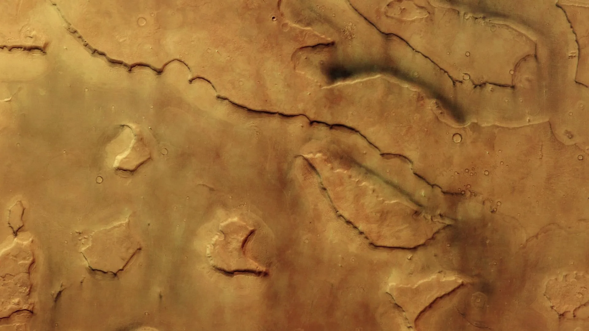 Mars Dust Devils: 30 Spotted Hiding in Mamers Valles Mars dust devils — A dark tan-colored patch of Mars, with an area of lower land running between the left and center of t
