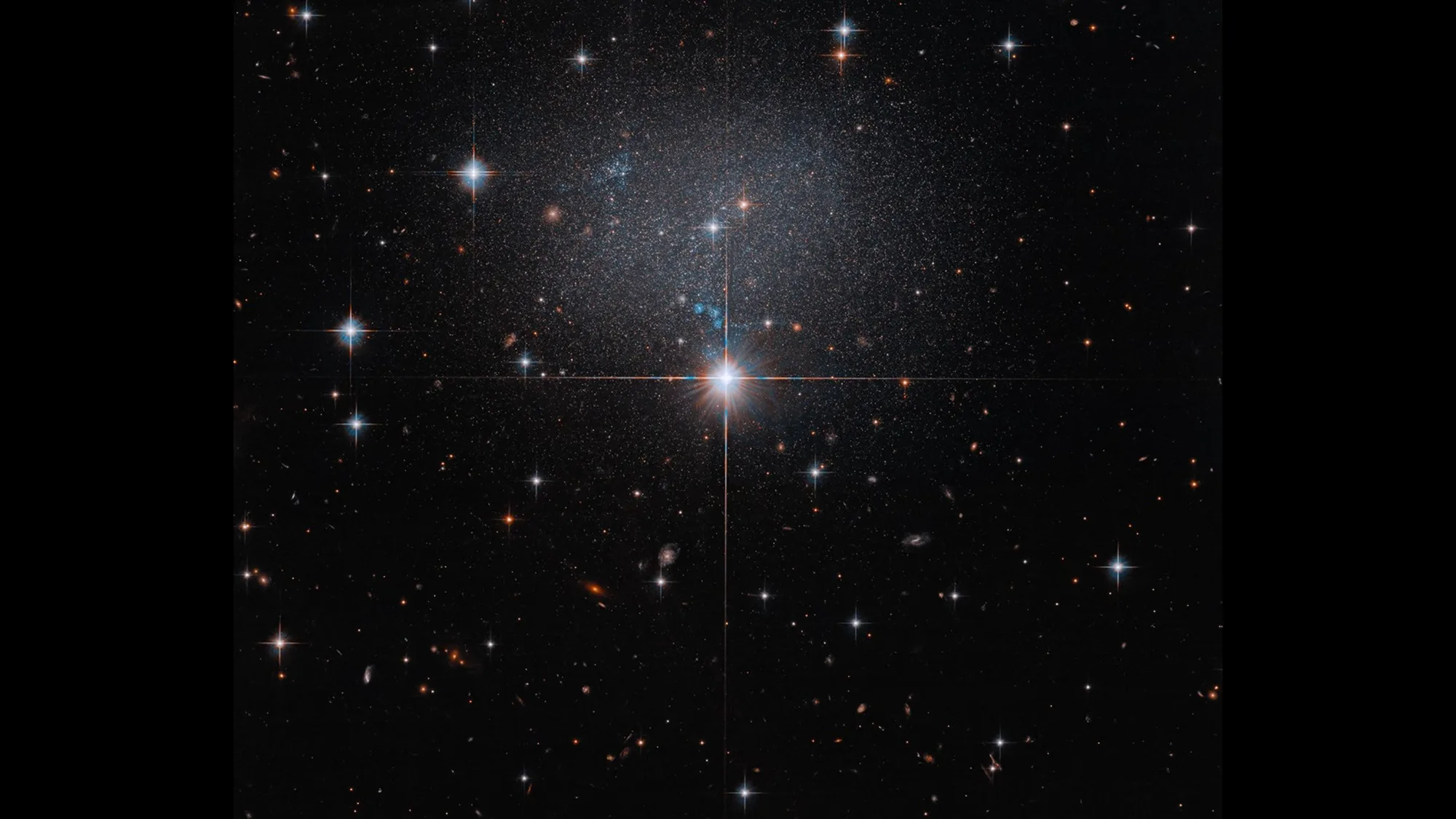 Hubble Captures Dwarf Galaxy ESO 490-017 at 23 Million Light-Years Hubble dwarf galaxy — A bright central star stands out in a field of stars against the dark backdrop of space.