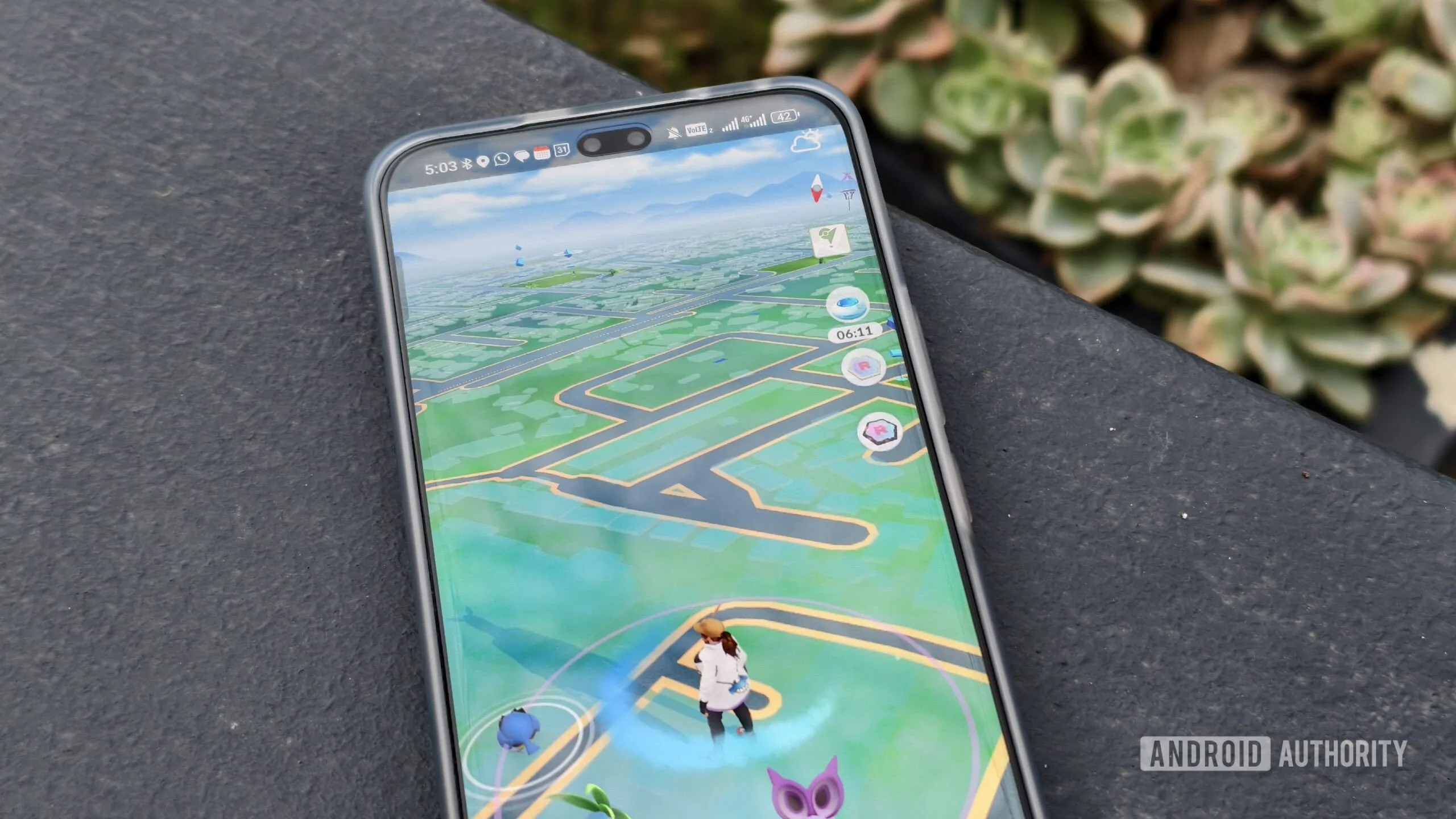 Pokémon Go Players May Have Trained Military Drones Without Knowing Pokémon Go drone training — pokemon go on a smartphone on a concrete wall
