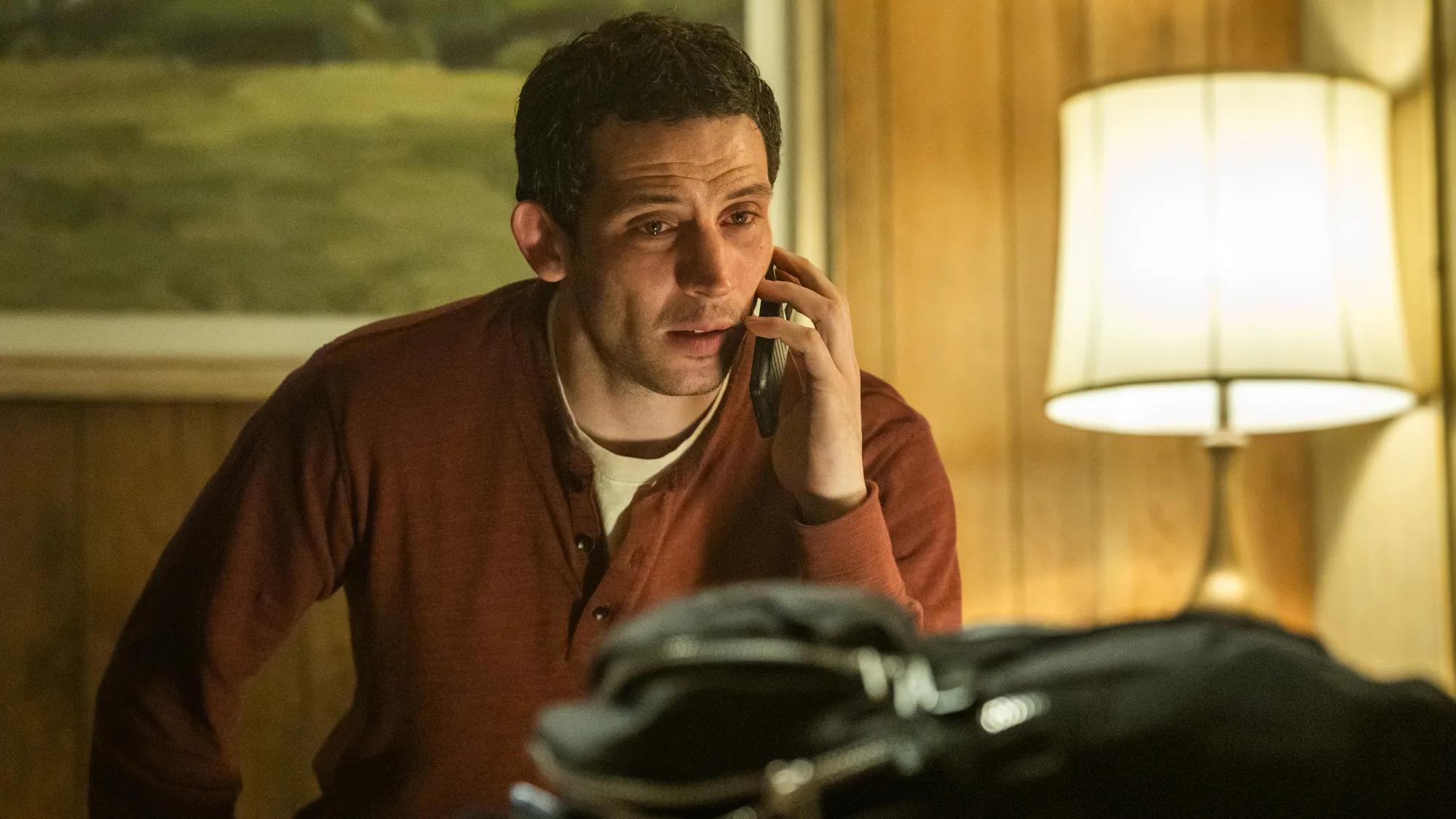 Disclosure Day Review: Spielberg's Latest Is a Major Near-Miss A brown-haired man in a hotel room, talking on a phone.