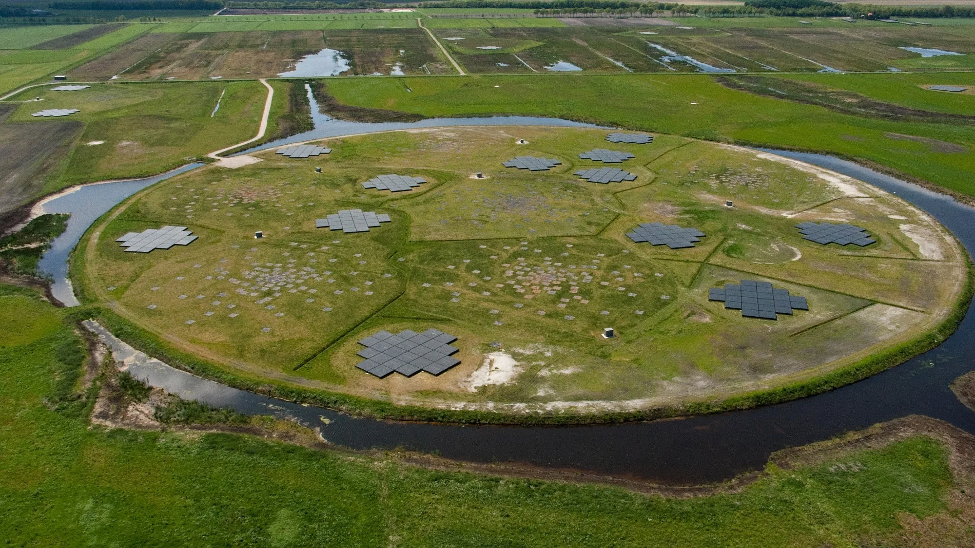 RAD-BAARG: New Cosmic Shock Wave Discovery Explained an aerial view of a round plot of land circled by a canal. on the round plot of land are arrays of square-shaped pieces
