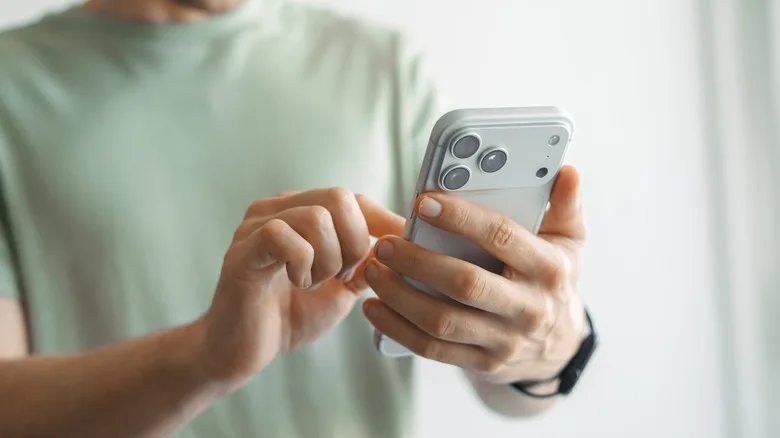 Apple's New Genmoji Creation Tool in iOS 27 Explained A person holding an iPhone