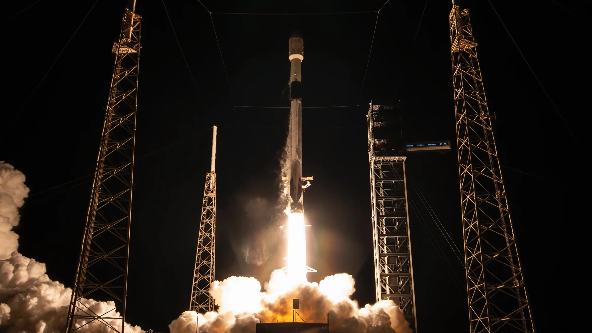 SpaceX Falcon 9 Launches 15,400-lb SiriusXM Satellite on 17th Booster a black and white rocket launches into a dark night sky