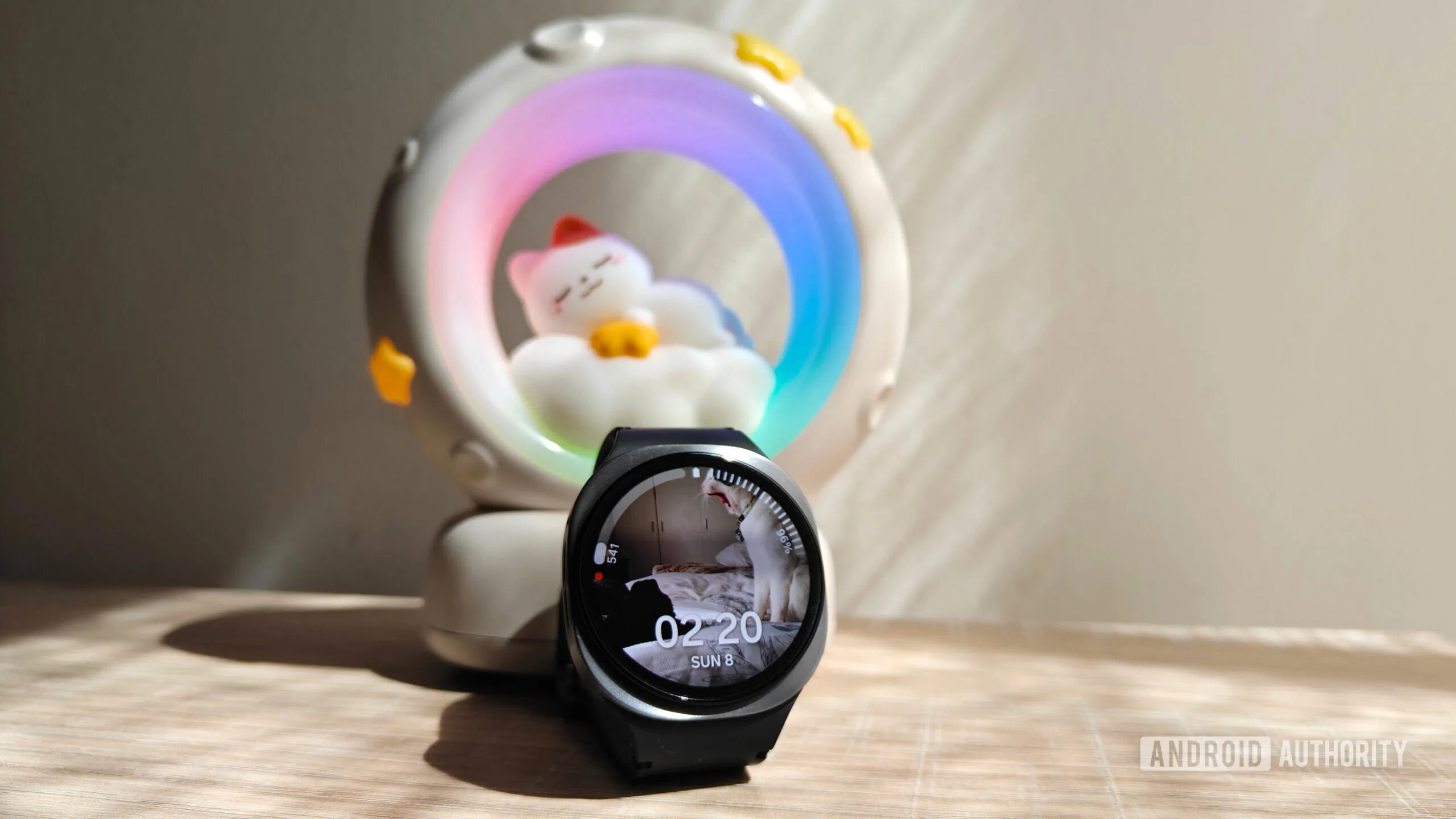Samsung Health's New Vitals Dashboard: What It Needs to Get Right a galaxy watch 8 in front of a night light with a cat sleeping on a moon