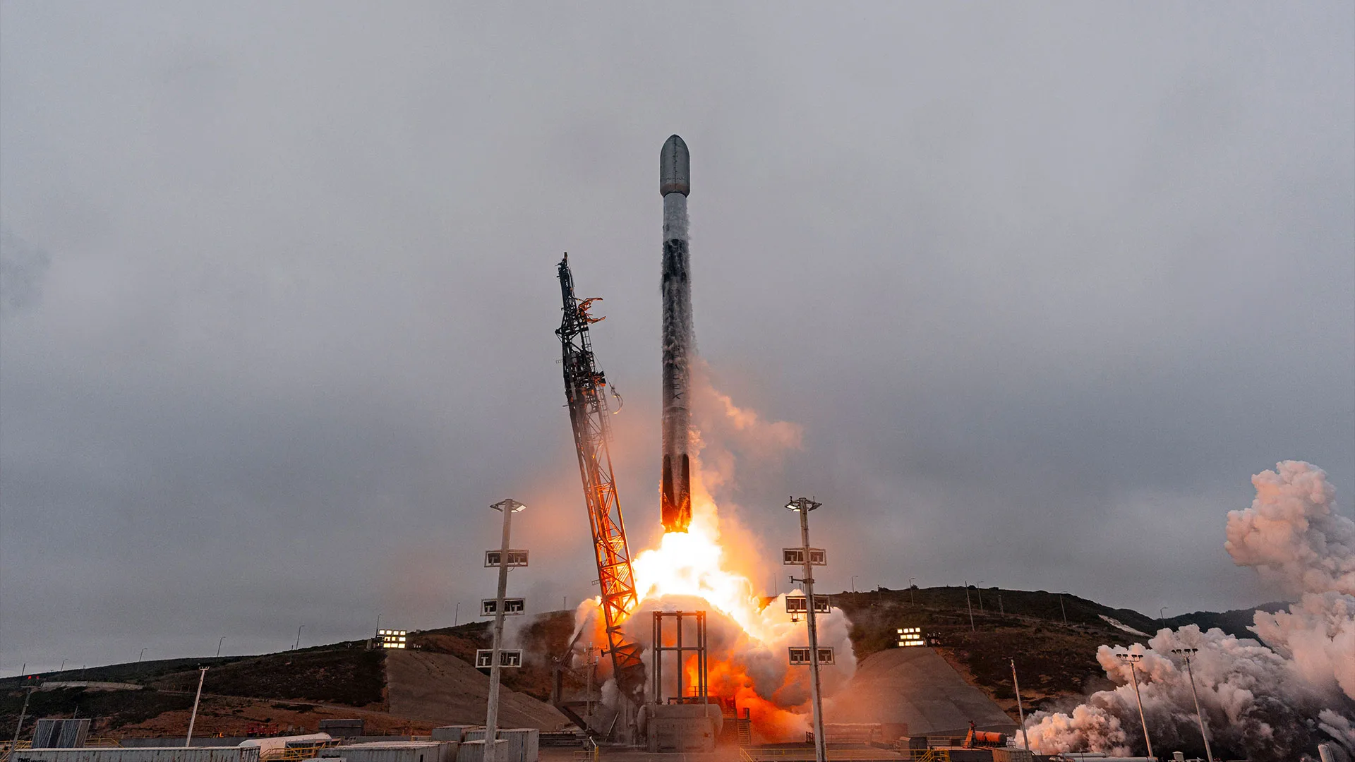 SpaceX Starlink Launch 17-54: 24 New Satellites Lift Off on IPO Week Starlink satellites launch — a white and black rocket lifts off into overcast cloudy skies