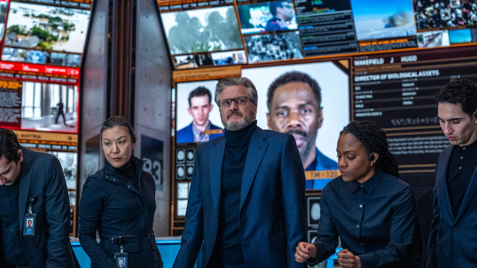 Disclosure Day Review: Spielberg's Latest Is a Major Near-Miss A group of agents in suits standing in front of security monitors.