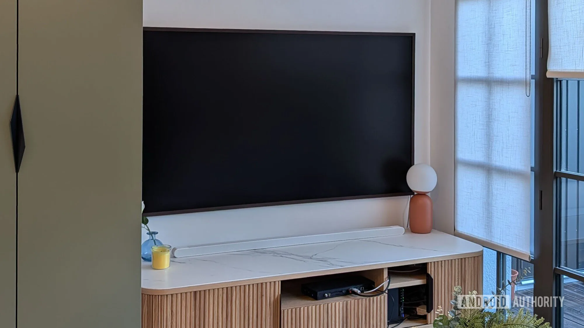 Google TV Projector Review: Why I'd Skip My Next TV Purchase Google TV projector — samsung frame tv pro screen off black display on wall