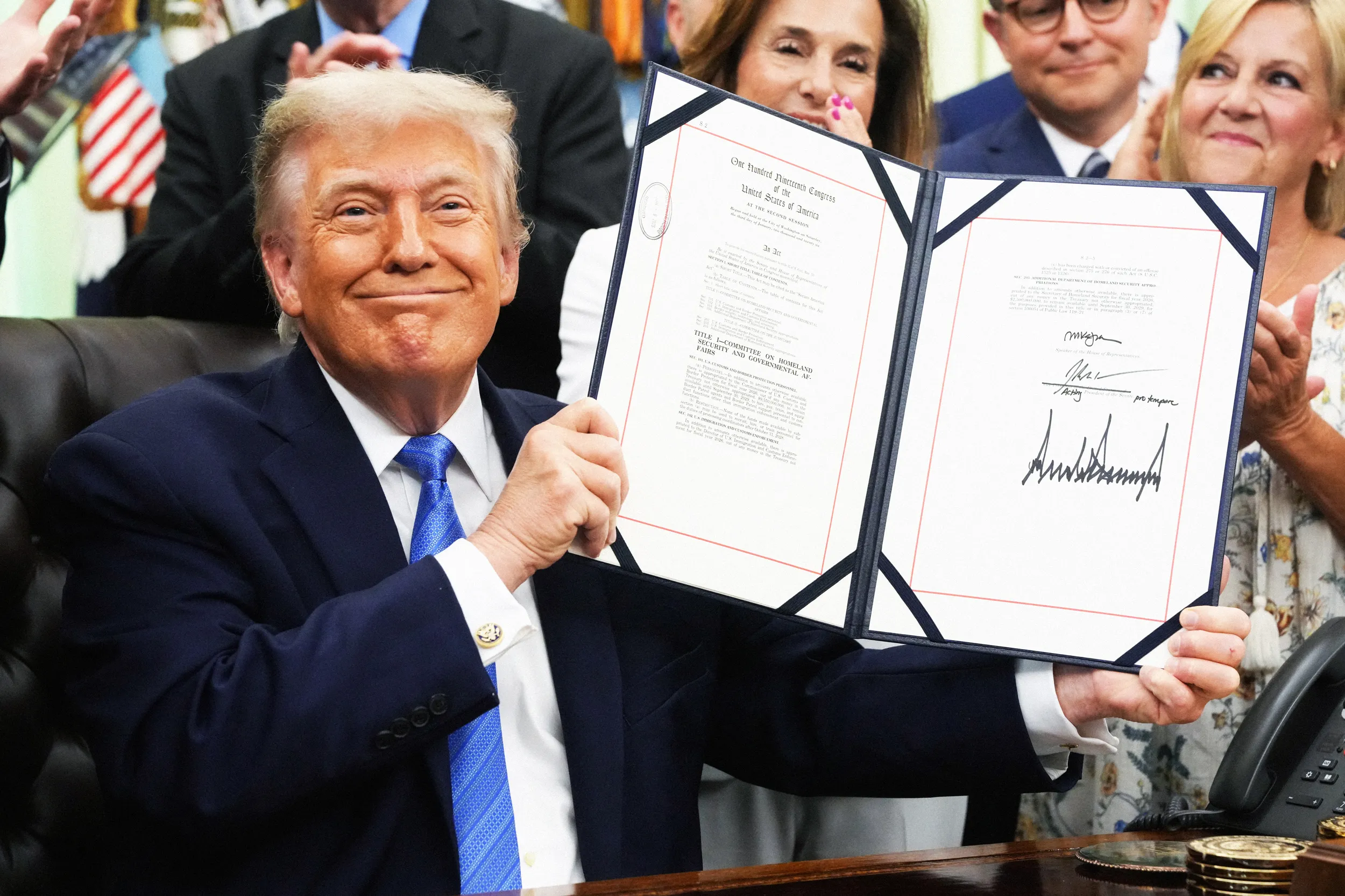 World Cup 2026 Visa Crisis: How Trump's Border Rules Are Hitting Playe World Cup 2026 visa — US President Donald Trump holds up the Secure America Act after signing it in the Oval Office of t