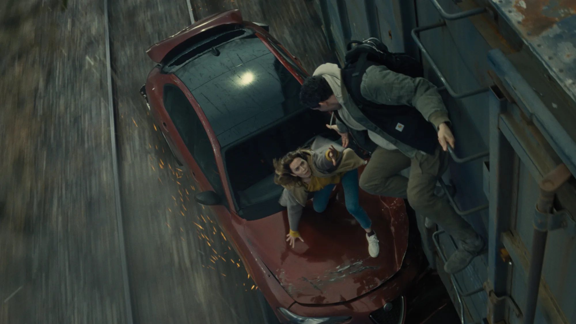 Disclosure Day Review: Spielberg's Latest Is a Major Near-Miss A man and a woman attempting to board a train from their stricken car that is being dragged along the track.