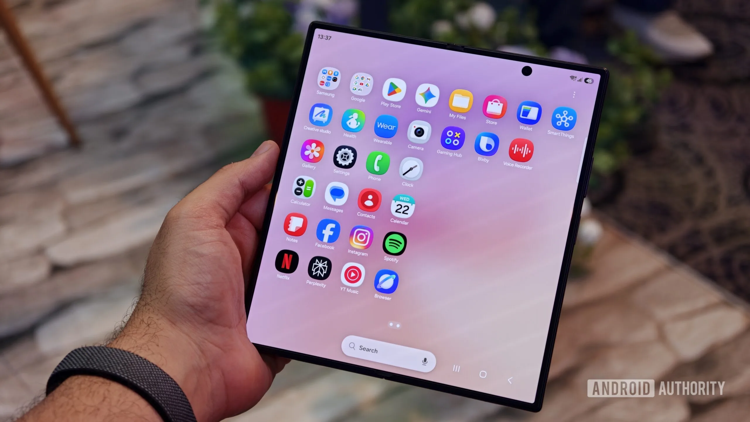 The Z Fold 8 crease is back after a week, but that’s not the full stor Z Fold 8 crease — A person holding the unfolded Samsung Galaxy Z Fold 8 Ultra showing the full app drawer screen grid on