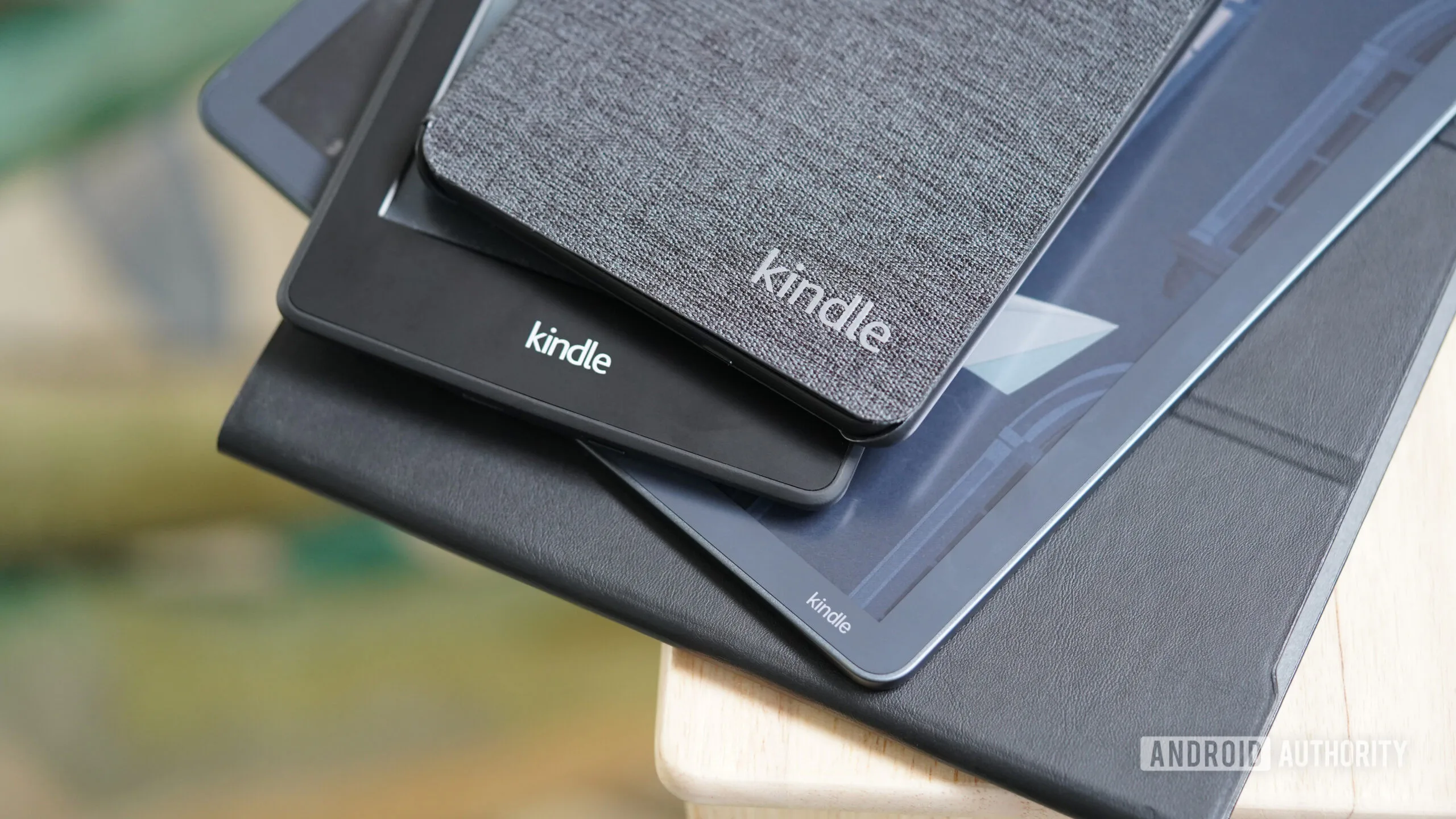 Amazon Custom Chips: The 2027 Plan to Power Kindle and Fire TV Amazon custom chips — A stack of Amazon Kindles rests on a bedside table.