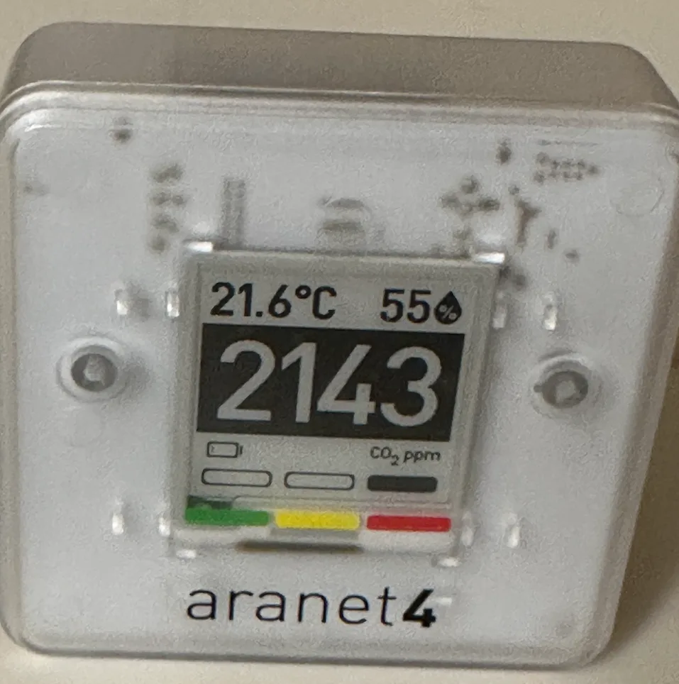 CO2 in Meeting Rooms Is Quietly Wrecking Your Team's Decisions CO2 in meeting rooms — Portable CO2 monitor reading 2143 ppm