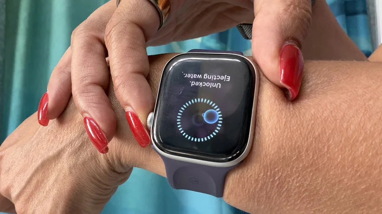 Apple Watch Water Lock Explained: What It Actually Does Fingers touching an Apple Watch to eject water.