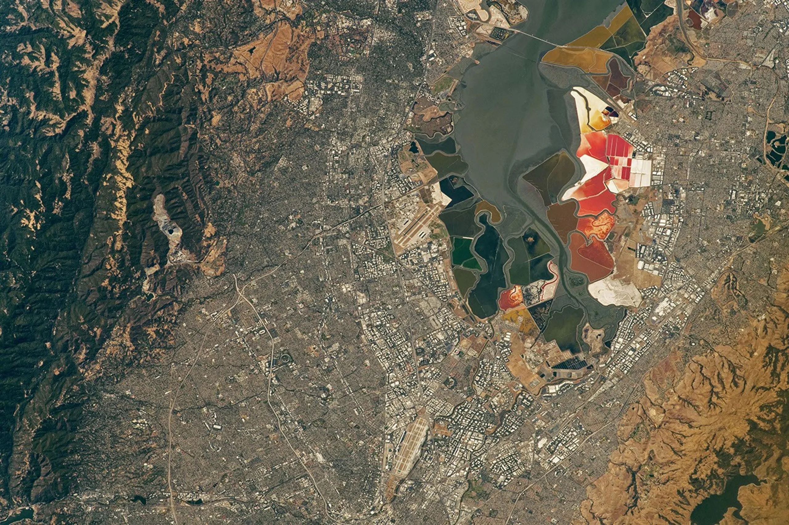 NASA's ISS Photos Reveal 2026 World Cup Stadiums From 250 Miles Up An aerial view of the San Francisco Bay Area Stadium, middle-left, is surrounded by urban infrastructure. Colorful ponds