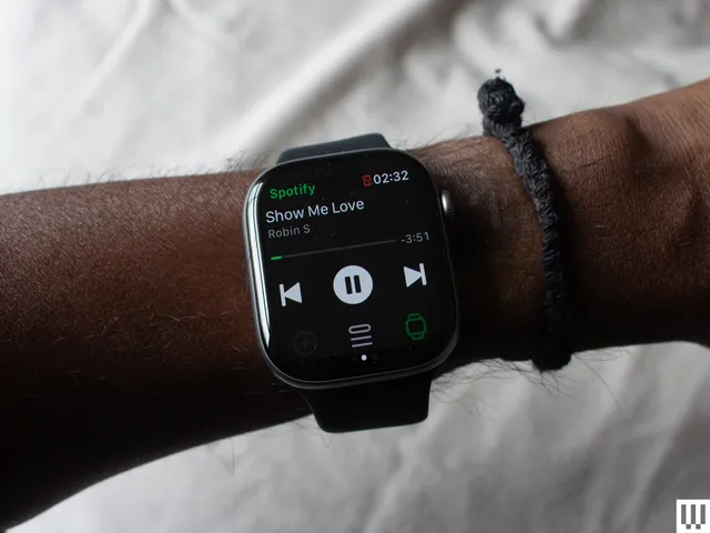 Best Smartwatches 2026: The Essential Buying Guide best smartwatches 2026 — Closeup of a persons wrist wearing a smartwatch with a digital screen showing music mode