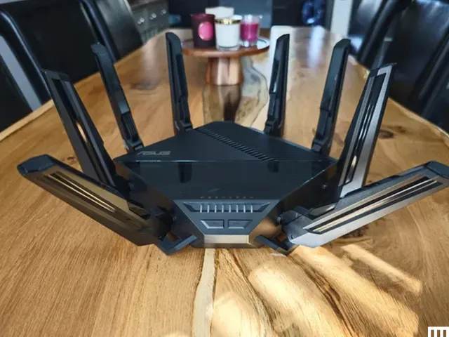 Best Wi-Fi Routers 2026: Top 7 Picks After Testing 40+ best Wi-Fi routers — Black square device sitting on wooden table with 8 prongs sticking out 4 on each side