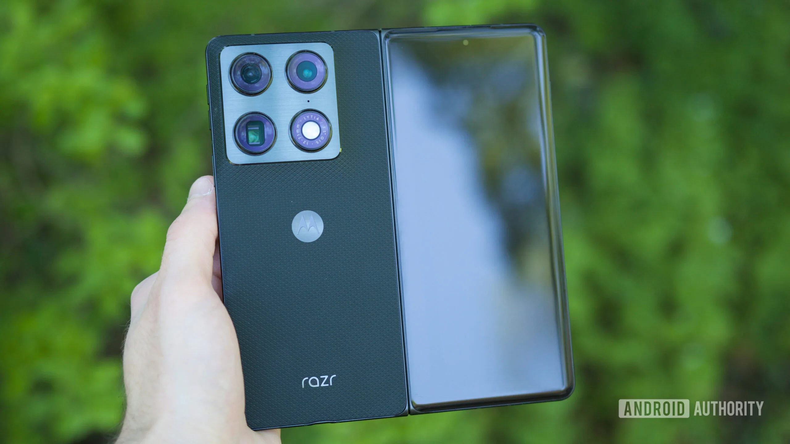 4 Best Fold 8 Ultra Alternatives for Buyers Watching the Price Someone holding the Motorola Razr Fold with the phone unfolded.