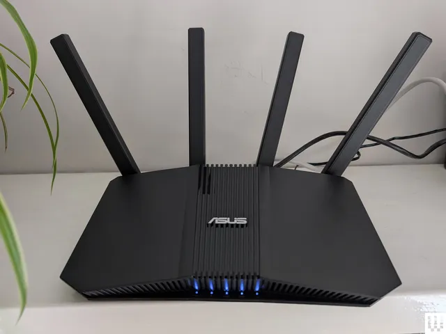 Best Wi-Fi Routers 2026: Top 7 Picks After Testing 40+ Asus RTBE58U a black angular wifi router with 4 antennae sticking up from the back