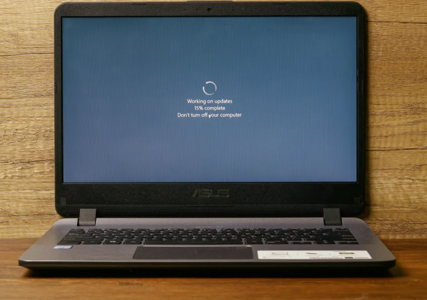 Microsoft Security Patches Hit a Critical 570-Flaw Record Microsoft security patches — A picture of a windows laptop in its updating stage, saying do not turn off the computer.