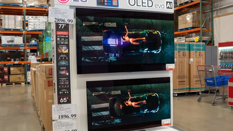 OLED TVs 2026: The Expert Case for Paying More A store display featuring LG OLED evo AI TVs. One is a 77-inch screen priced at $2,896.99.