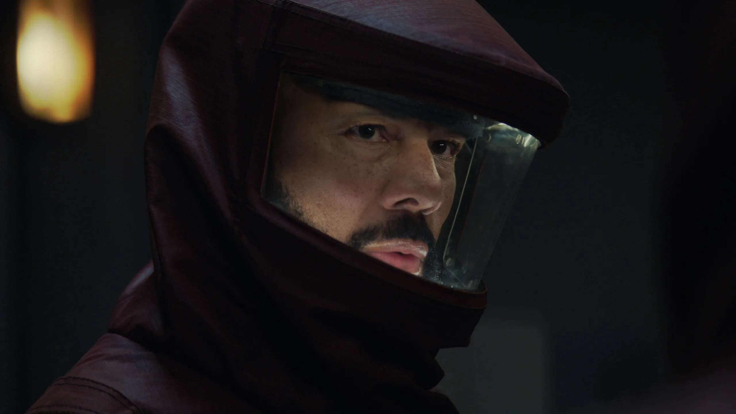Silo Season 3: Complete Guide to the New Apple TV+ Thriller a man wearing a dark red hazmat suit