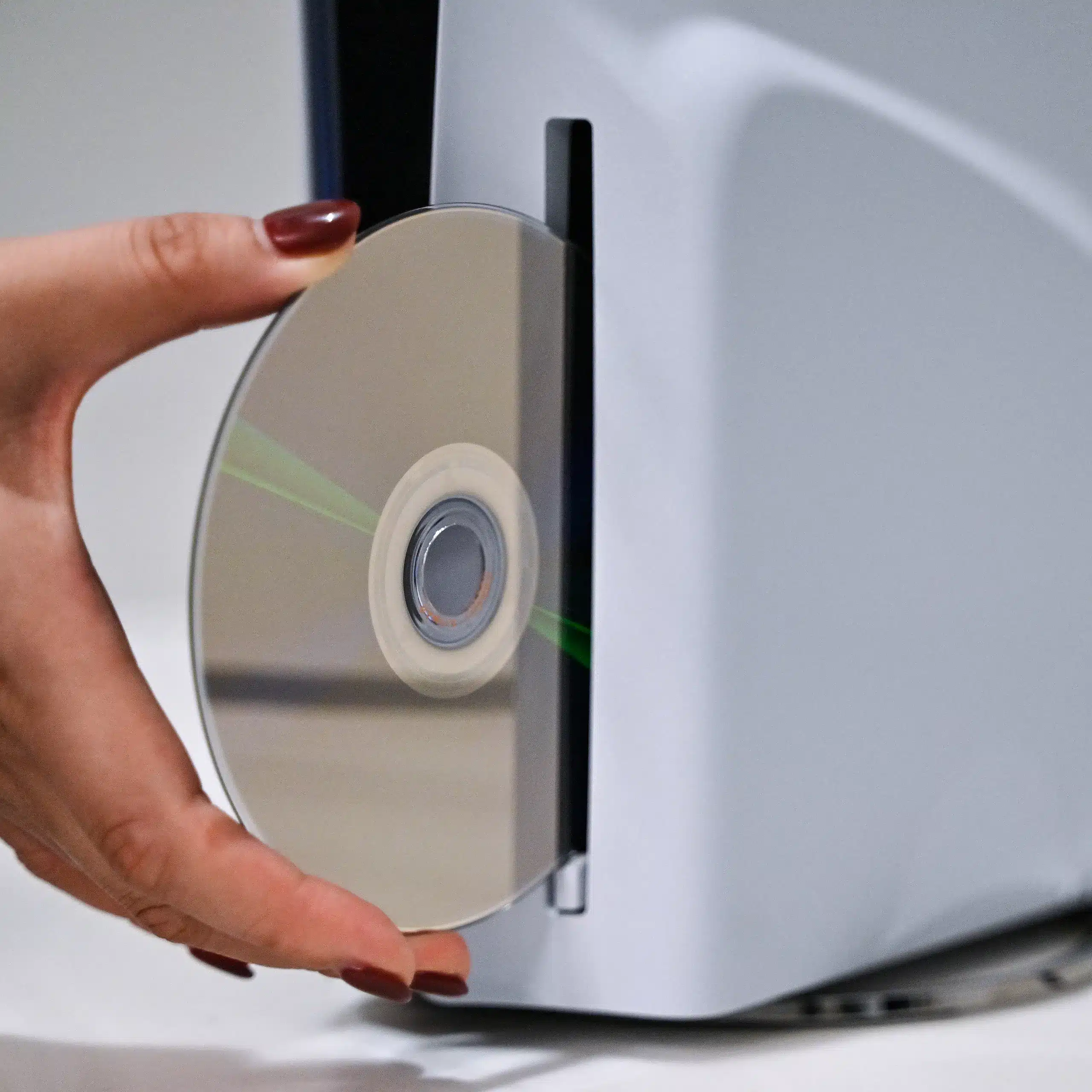 PlayStation Physical Games: Sony's 2028 End Date Explained PlayStation physical games — A PlayStation employee demonstrates how to put a disc into the PlayStation 5.