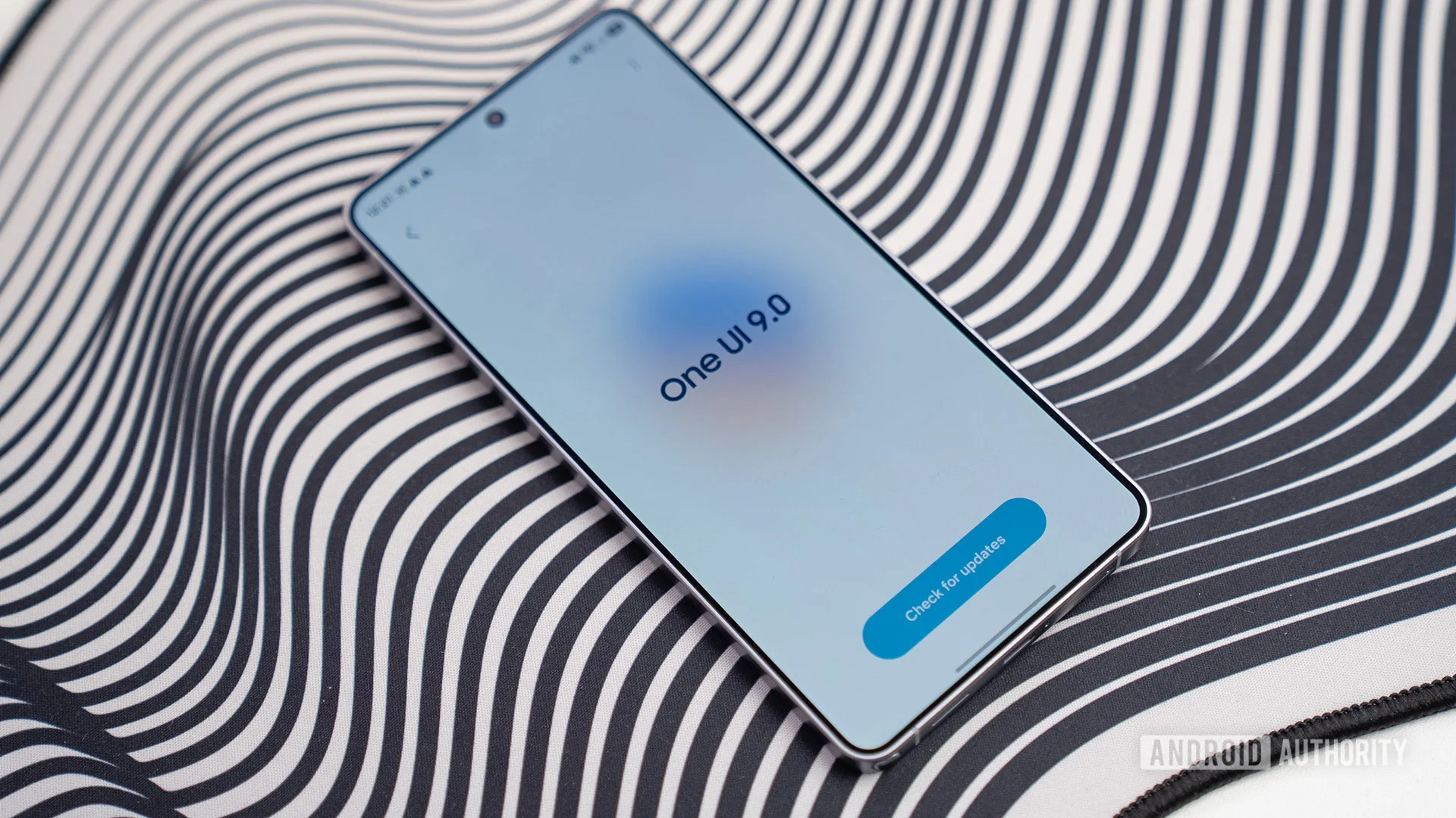 Galaxy S26 One UI 9 Beta 4 Targets the Annoying Stuff One UI 9 beta 2026 — OneUI 9 splash screen S26 Ultra phone lay down