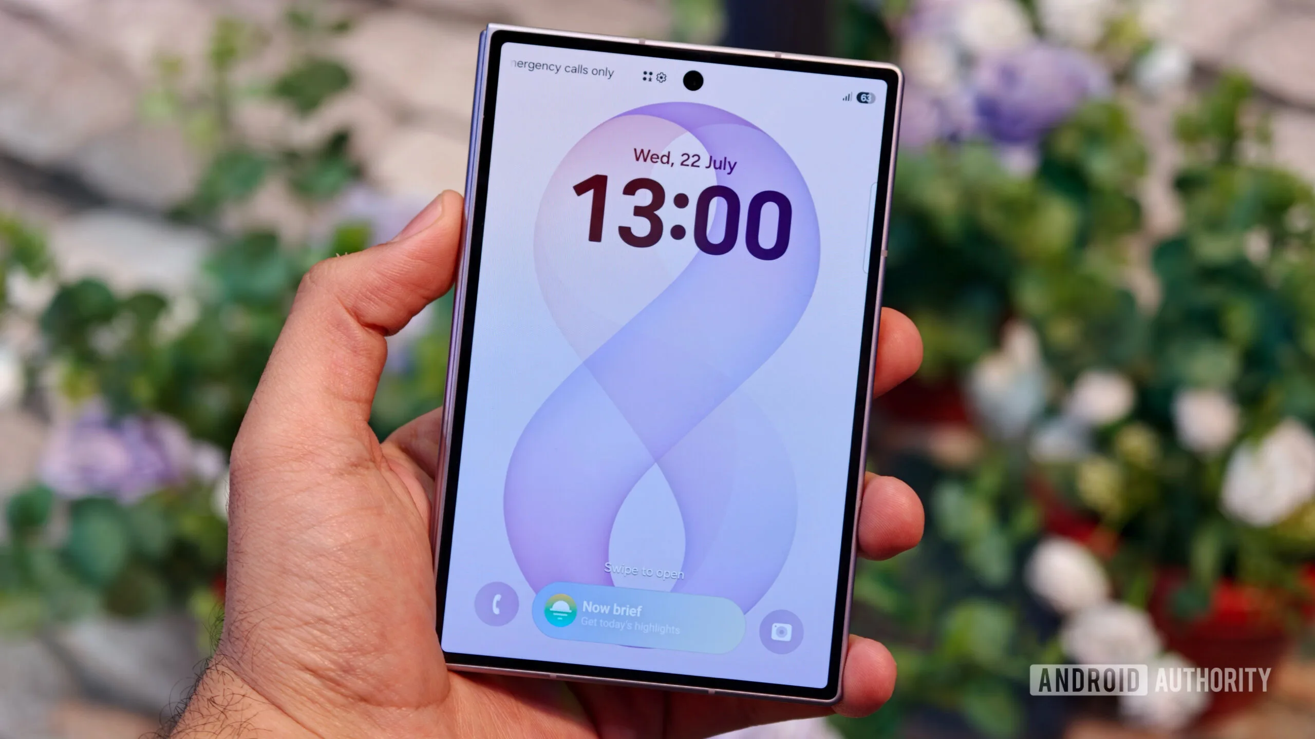 Pixel 11 Pro Fold Alternatives: 4 Better Buys for 2026 A hand holding the closed Samsung Galaxy Z Fold 8 showing its outer cover display with a digital clock and wallpaper