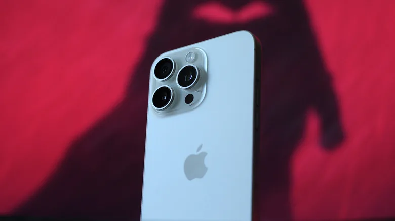 Switching From iPhone Has 5 Essential Trade-Offs switching from iPhone — A white iPhone 15 Pro Max against a red background