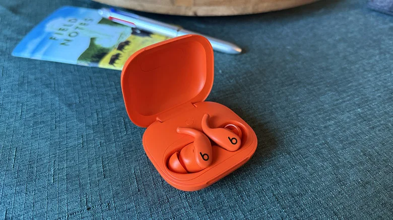 Affordable AirPods Alternatives: 4 Best Earbuds for Less Powerbeats Fit earbuds sitting in their charging case.