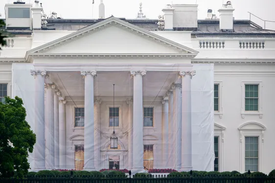 Build the Wall Game Pulled After Tetris Company Complaint Build the Wall game — A protective tarp with a photo on it covers the scaffolding and the columns on the North Portico o
