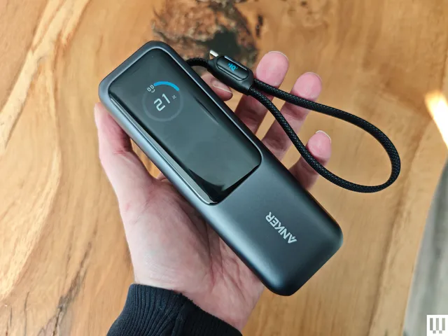 Prime Day Deals Under $100: 12 Picks Worth Checking Prime Day deals 2026 — A hand holding an Anker Laptop Power Bank, a black rectangular portable charger with long digital
