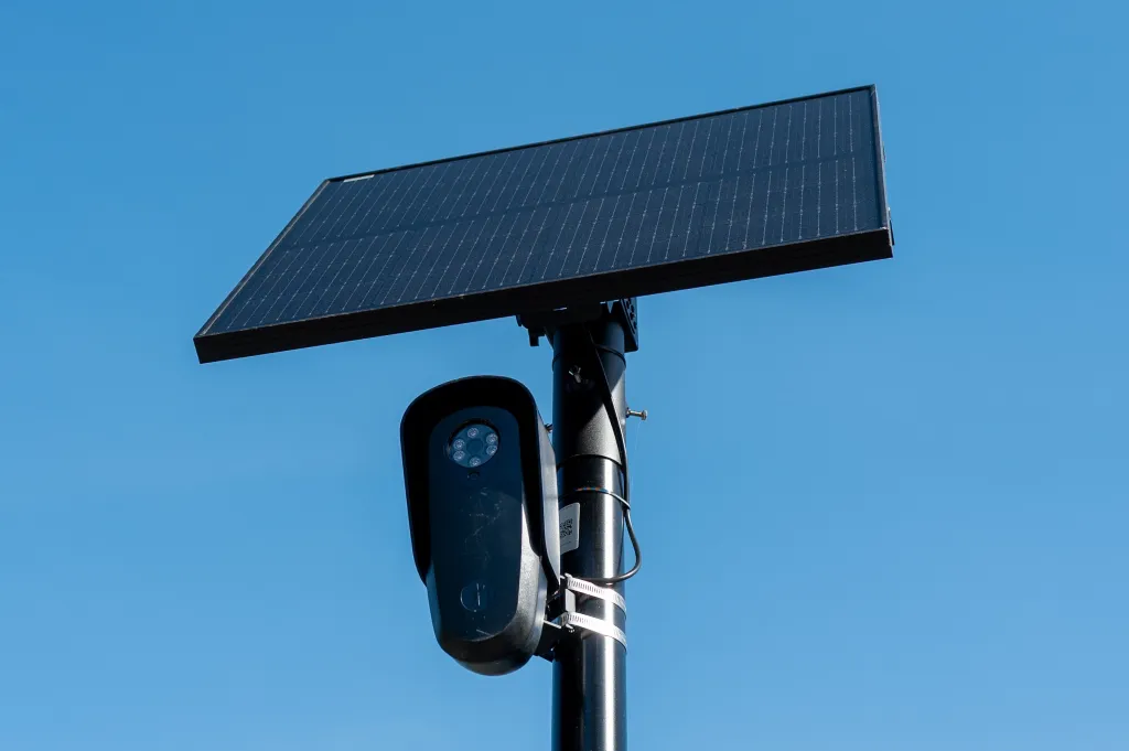 Flock Safety Cameras Face a Critical Fourth Amendment Test Flock license plate reader and camera with solar panel against a blue sky, Pleasant Hill, California, April 16, 2026.